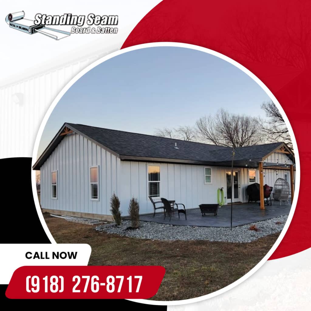A single-story residential home finished with white vertical board and batten metal siding and a dark shingle roof.