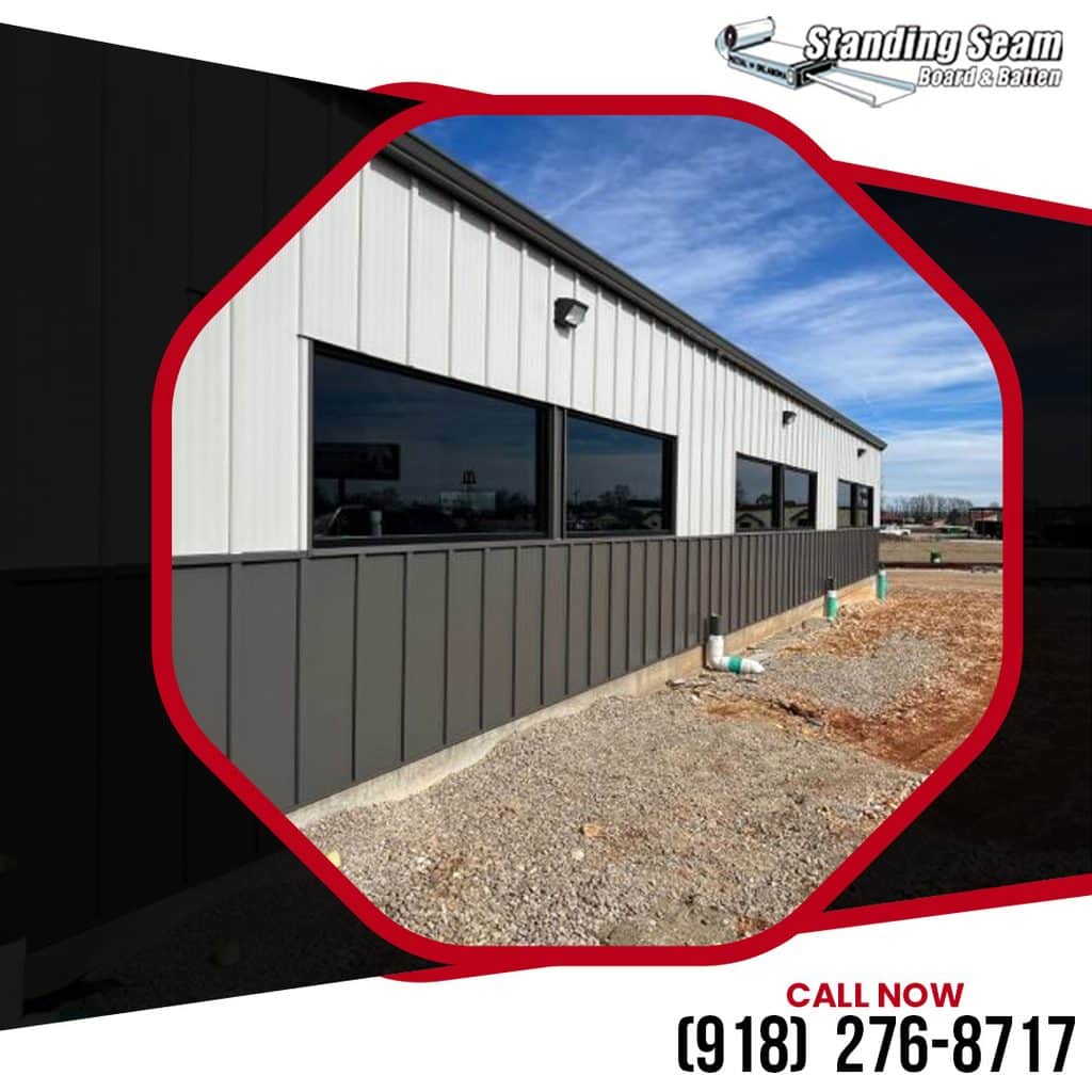Exterior of a commercial building featuring two-tone vertical metal siding with white top panels and dark gray wainscoting along the foundation.